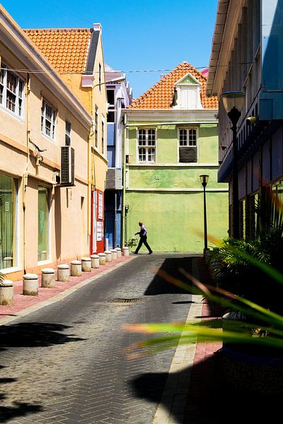 Streetscape of a man on the street in Punda, Willemstad, Curacao by Paul van Putten