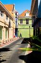 Streetscape of a man on the street in Punda, Willemstad, Curacao by Paul van Putten thumbnail