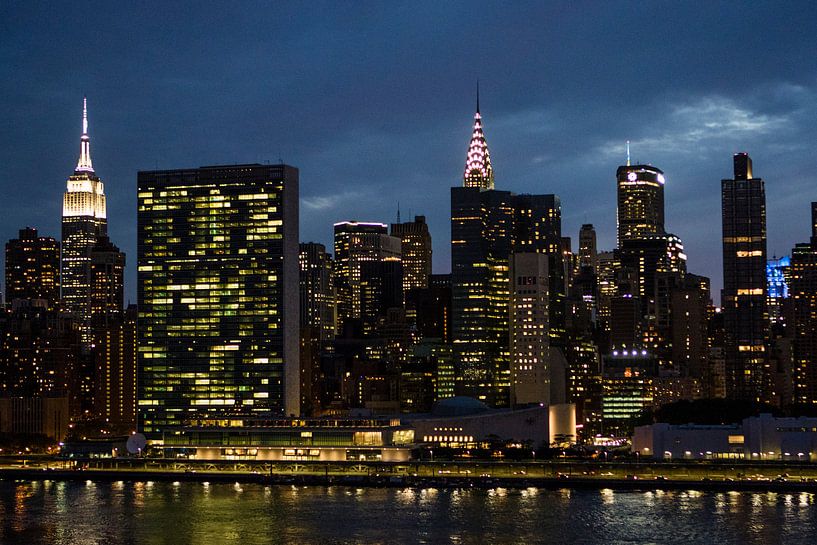 The skyline of Manhattan - New York City - with the Empire State Building, United Nations office in  by WorldWidePhotoWeb