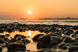 Gouden licht op de kiezelstenen van Medewi van Fotos by Jan Wehnert