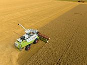 Combine harverster harvesting wheat during summer seen from above by Sjoerd van der Wal Photography thumbnail