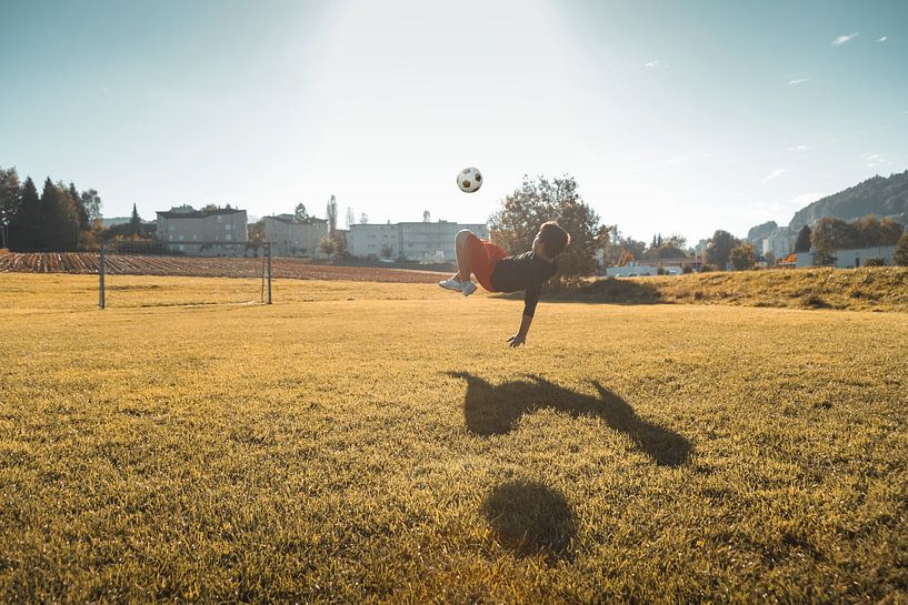 Coup de pied aérien de football dans la lumière du soir par Besa Art
