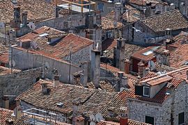 A tangle of red-roofed houses in a southern port town in Istria. by Gert van Santen