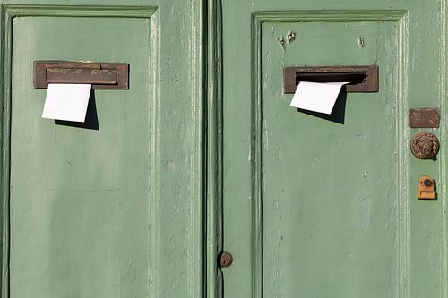 Reisfotografie. Dubbele groene deur met brievenbussen