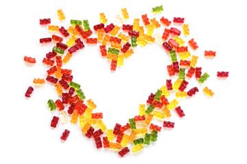 heart shape made of colorful gummy bears isolated with small shadow on a white background, love conc by Maren Winter