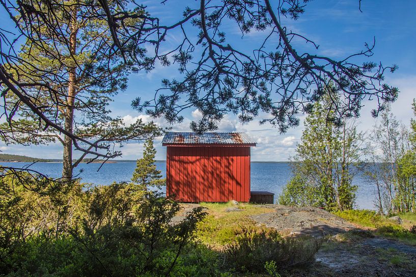 Red cottage at the coast in Sweden by Bianca Kramer