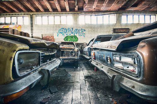 Dilapidated garage with Ford Capri's among others