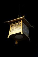 Golden lantern in serene dark surroundings