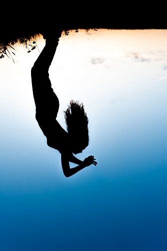 Silhouette of a young lady against the setting sun