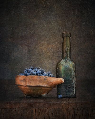 Still life with bottle and blueberries