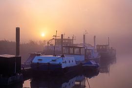 A misty sunrise on the waterfront with beautiful boats by Rick van de Kraats