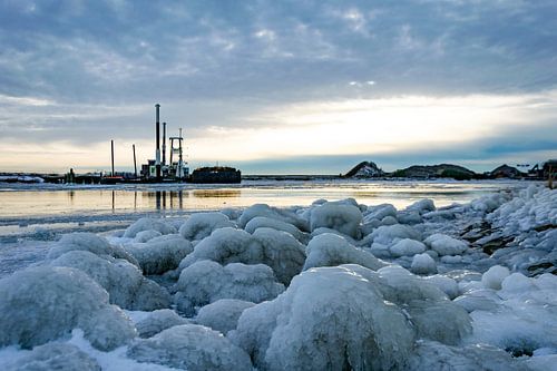 Thick layer of ice on the stones at the IJsselmeer