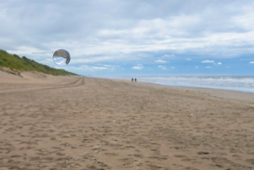 Lens ball on the North Sea beach by Peter Bartelings