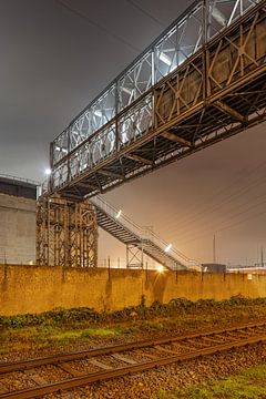 Pipleline bridge crossing road in industrial area at night, Antwerp by Tony Vingerhoets