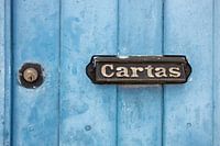 Vintage retro light blue door with modern keyhole and old-fashioned letterbox