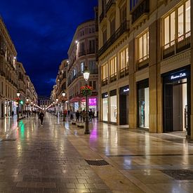 Calle Larios, the shopping street of Malaga, in the evening. by Monique van Helden