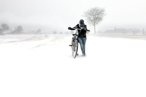 Girl with bike in blizzard in Zeeland