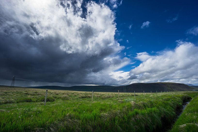 Iceland - River with green meadow and dark thunderstorm clouds by adventure-photos