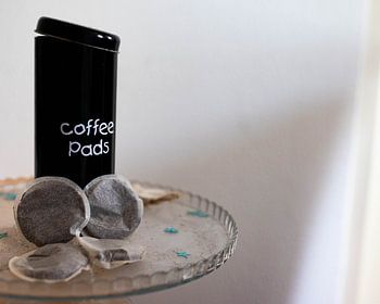Coffee pads tin on a decorative tray
