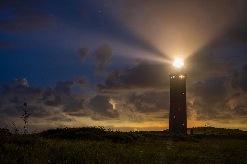 Lighthouse in the dunes with lightbeams at night by Sjoerd van der Wal Photography