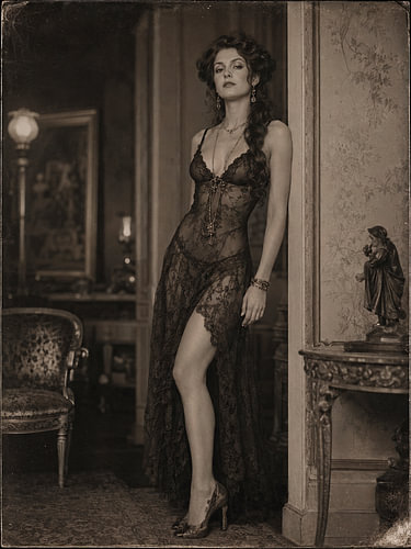 Seductive woman in vintage laced slip in 1920 interior.