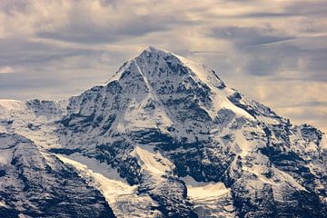 The sun breaks through the clouds, above the Mönch by Reinier Holster