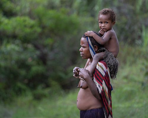 Moeder draagt haar kind op haar rug
