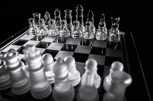 Chess Pieces on Glass Game Board