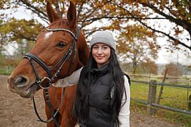 Training with the bay Oldenburg mare on a riding arena