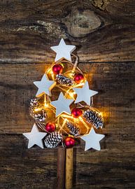 Illuminated Christmas tree decoration with ornaments, pine cones by Alex Winter