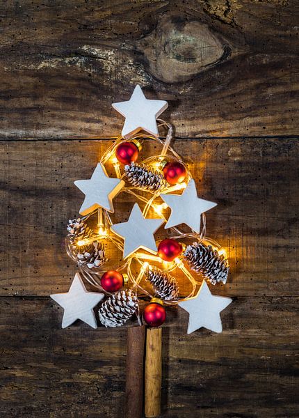 Illuminated Christmas tree decoration with ornaments, pine cones by Alex Winter