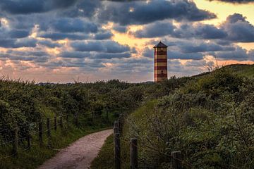 Lighthouse Dishoek under colorful clouds by R Smallenbroek