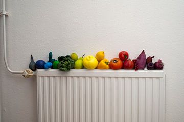 Rainbow fruit and vegetables (partly painted), on old-fashioned heating by Irene Cecile