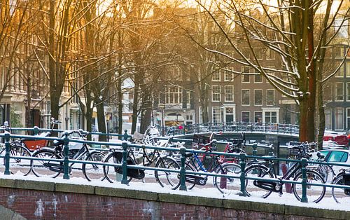 Cycling on the bridge in Amsterdam by Dennis van de Water