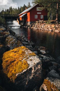 Typical red white Swedish water mill