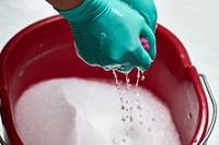 Hands wring out cleaning rags