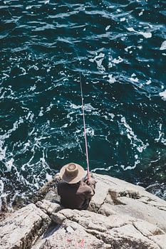 Een visser op de rotsen aan de oostkust van Noord Korea