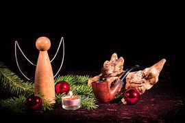 Wooden angel and pipe decorated with Christmas firs and Christmas tree balls by Hans-Jürgen Janda