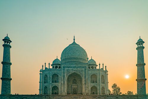 Sunrise with a green glow over the Taj Mahal temple in Agra India.