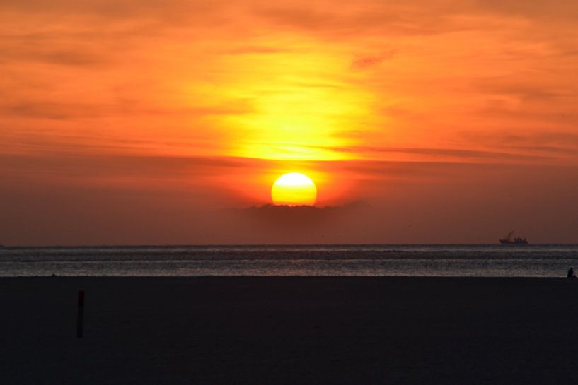 zonsondergang aan de kust van Texel met een vissersboot aan de horizon by tiny brok