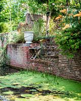 Brick stairs from city canal with lots of greenery