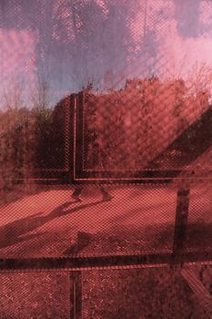 Walking feet behind red glas.