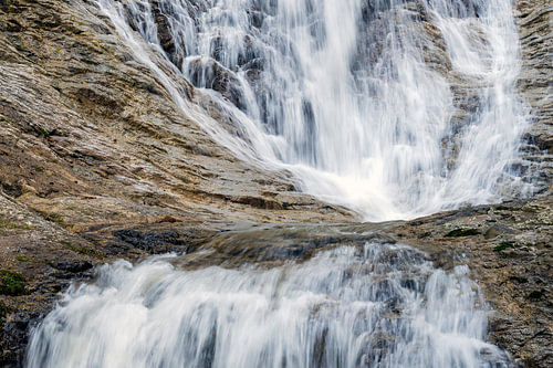 Powerful waterfall over rock face