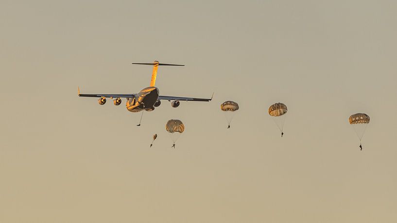 U.S. Air Force C-17 Globemaster III drops paratroopers. by Jaap van den Berg