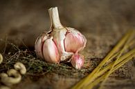 Garlic, spaghetti, thyme & cashew nuts on wood by Miranda van Hulst thumbnail