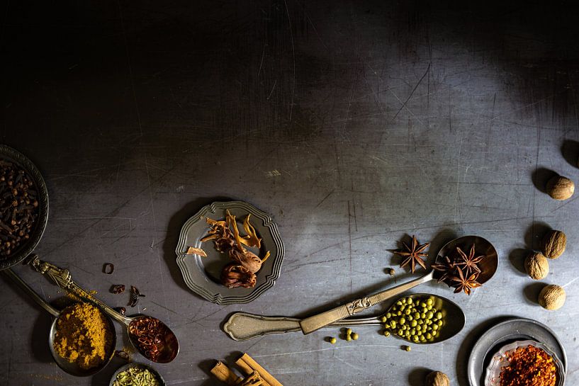 Spices on an old griddle by Saskia Schepers