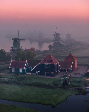 Zaanse Schans: Historic Windmills at Sunrise in the Mist by Ewold Kooistra