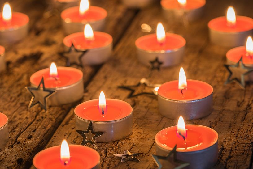 Traditional Advent and Christmas candles with silver star shapes decoration by Alex Winter