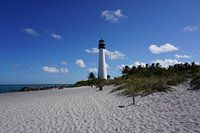 Peaceful island beach with white sand and lighthouse in Florida