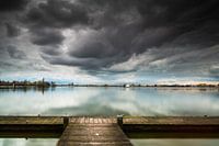 Wolkenlucht met aanlegplaats en zeilboot